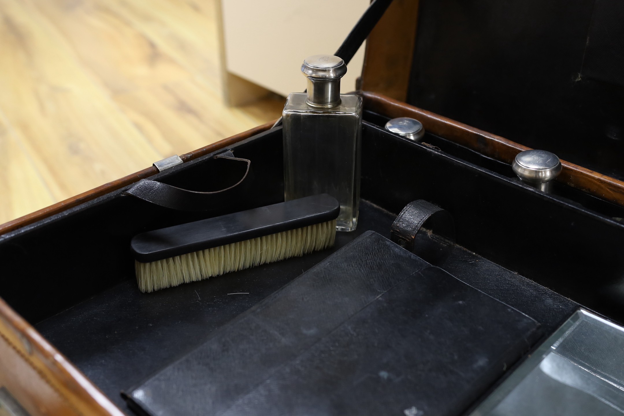 A Dupont travel suitcase, initialled ‘L.C.’ with French white metal mounted bottles